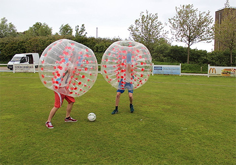 two people playing bubble football in a UK field